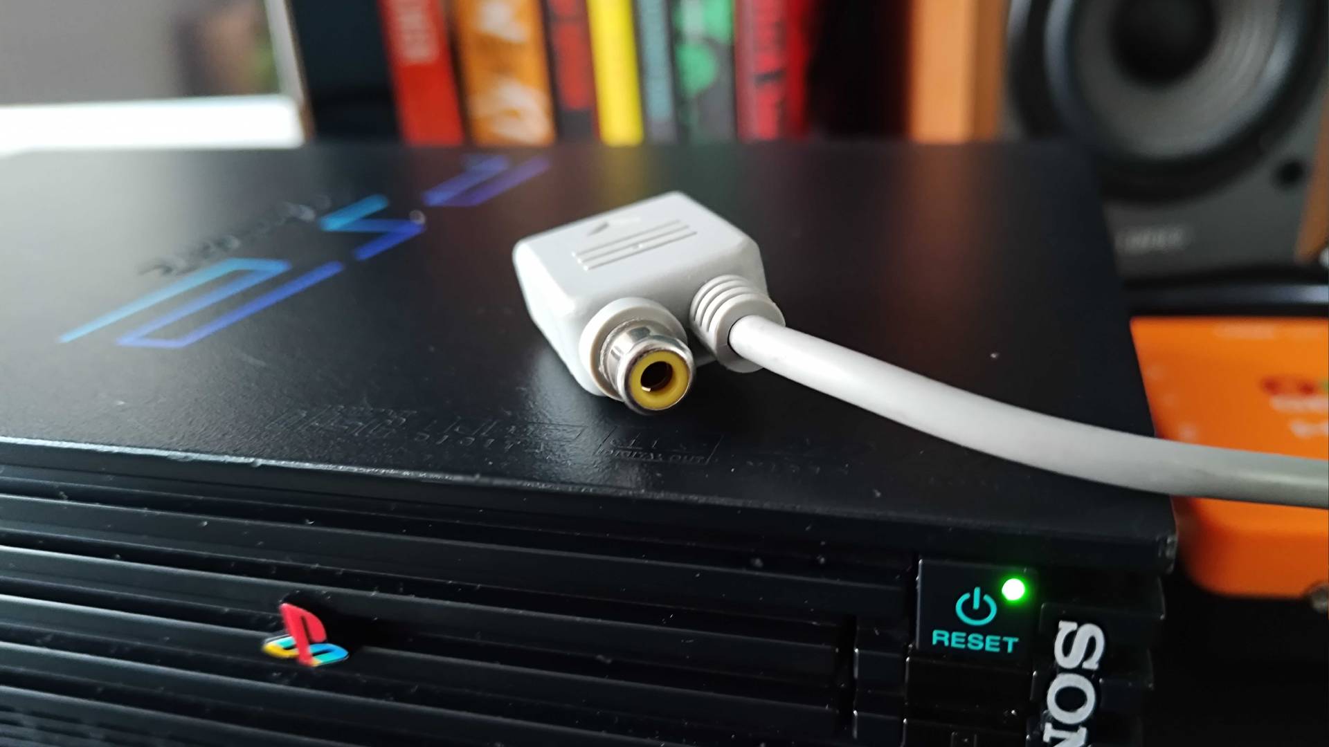 RGB SCART connector for PlayStation multiport with light gun composite jack sitting on PS2.