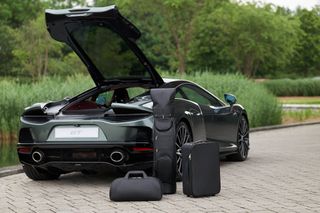 Luggage beside open boot of McLaren GT