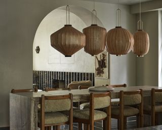 Woden dining table with large globe wood lights above
