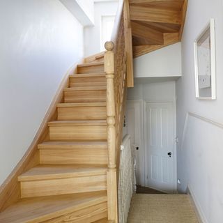 hallway wit h stairs and white walls