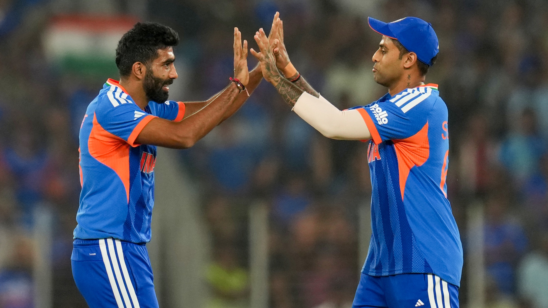Bowler Jasprit Bumrah and captain Suryakumar Yadav of India celebrate a wicket during an ICC Men's T20 World Cup match.