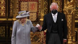 Queen Elizabeth II arrives with Prince Charles, Prince of Wales in the House of Lord's Chamber during the State Opening of Parliament