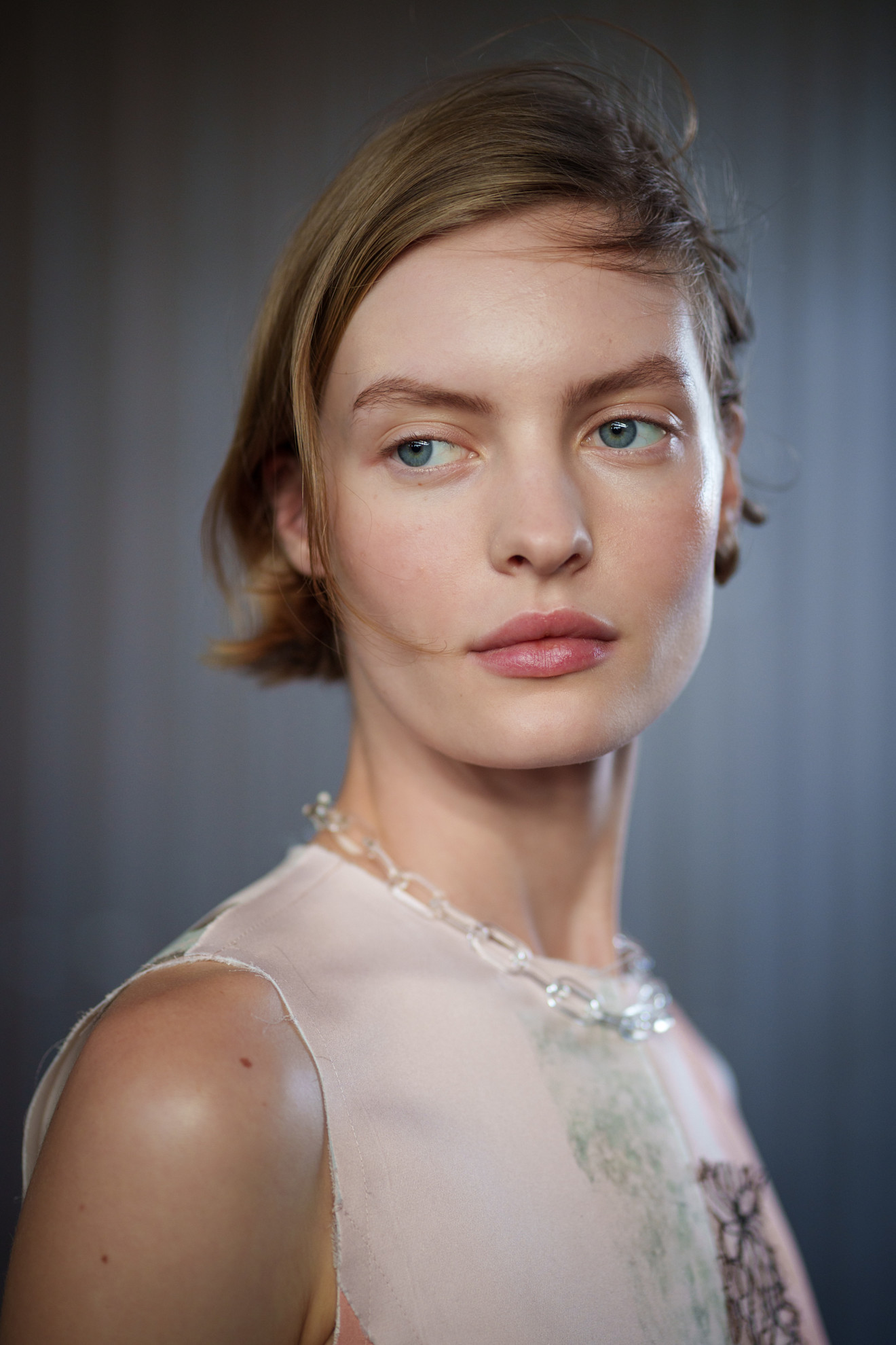 A model showing off a sideswept bixie cut.