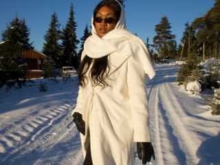 Nnenna Echem in a white coat and leather gloves