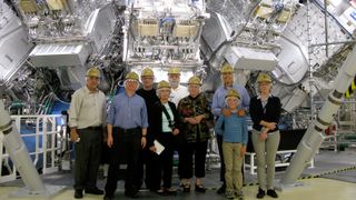 Lawrence Livermore National Laboratory Engineers Standing In Front Of A Nuclear Fusion Reactor