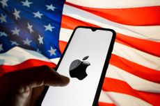 Apple logo displayed on phone with American flag in the background