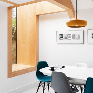 Light and bright kitchen diner with oak framed window seat