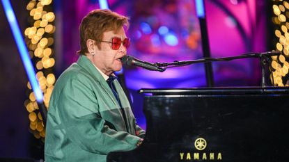 Elton John performs at Saks Fifth Avenue window unveiling and light show