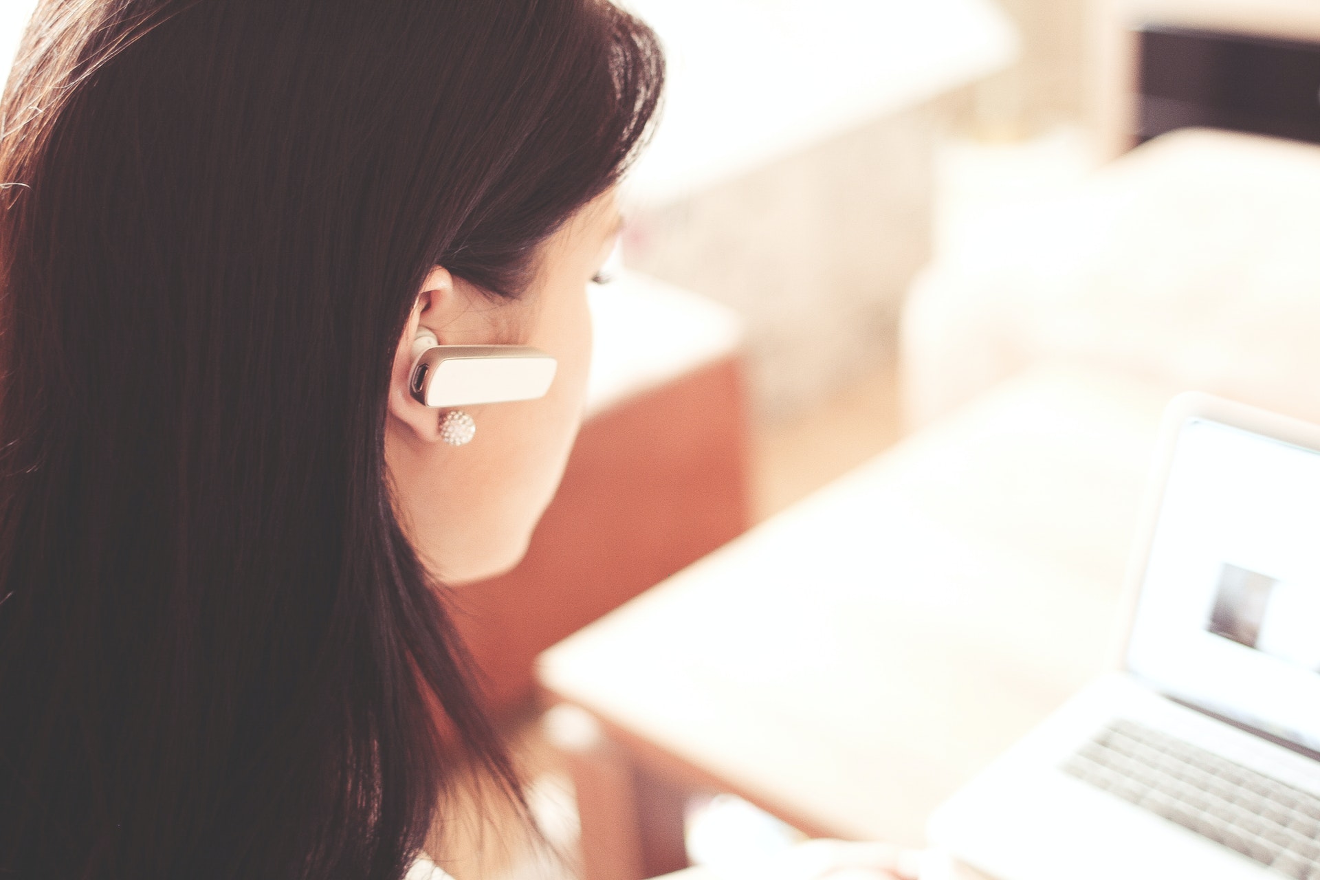 Customer support, woman wears earpiece