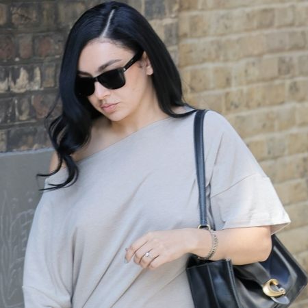 Charli xcx styled an indie-sleaze shirt dress with platform pumps and an oversized Coach Tabby Bag