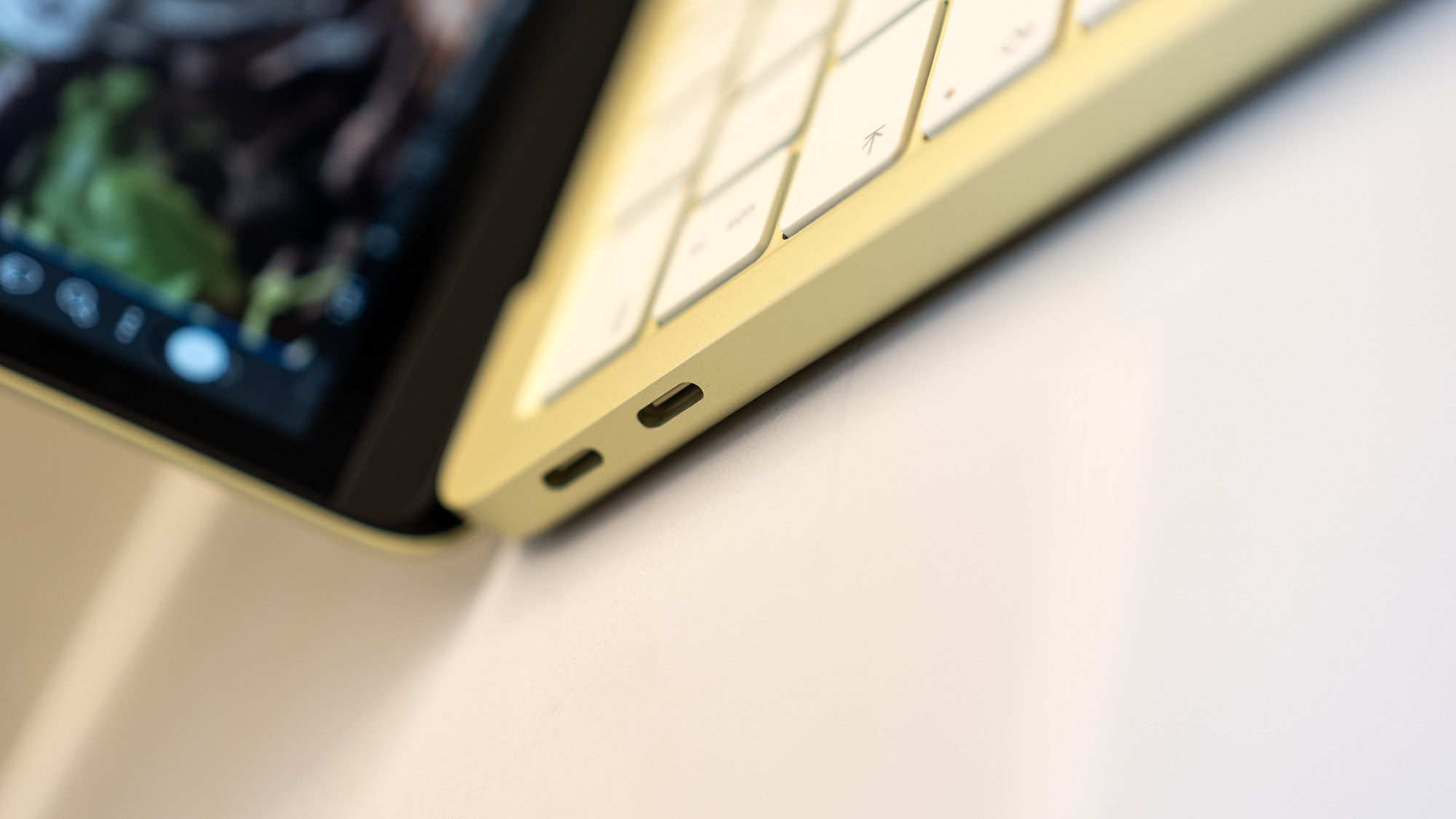 Apple MacBook Neo laptop in yellow on a desk