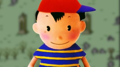 A clay figure of Ninten from Earthbound Beginnings in front of a blurred background