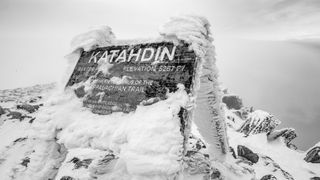 Katahdin summit sign covered in snow in winter, Appalachian Trail