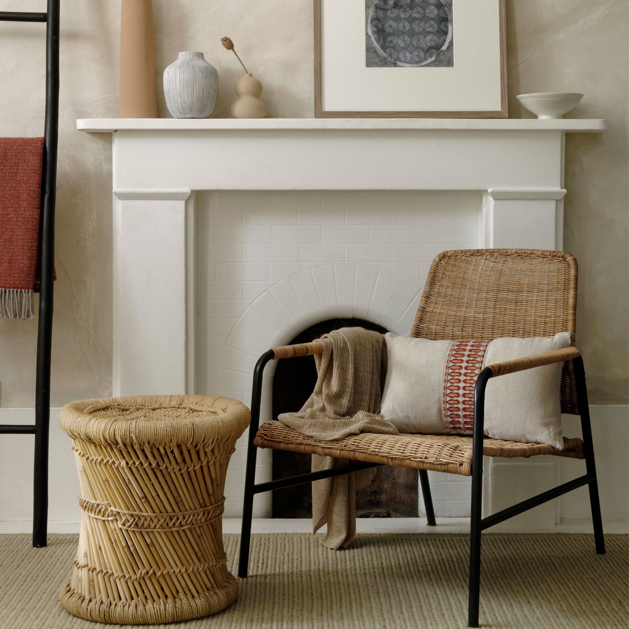 A minimal living room with a wicker chair and coffee table