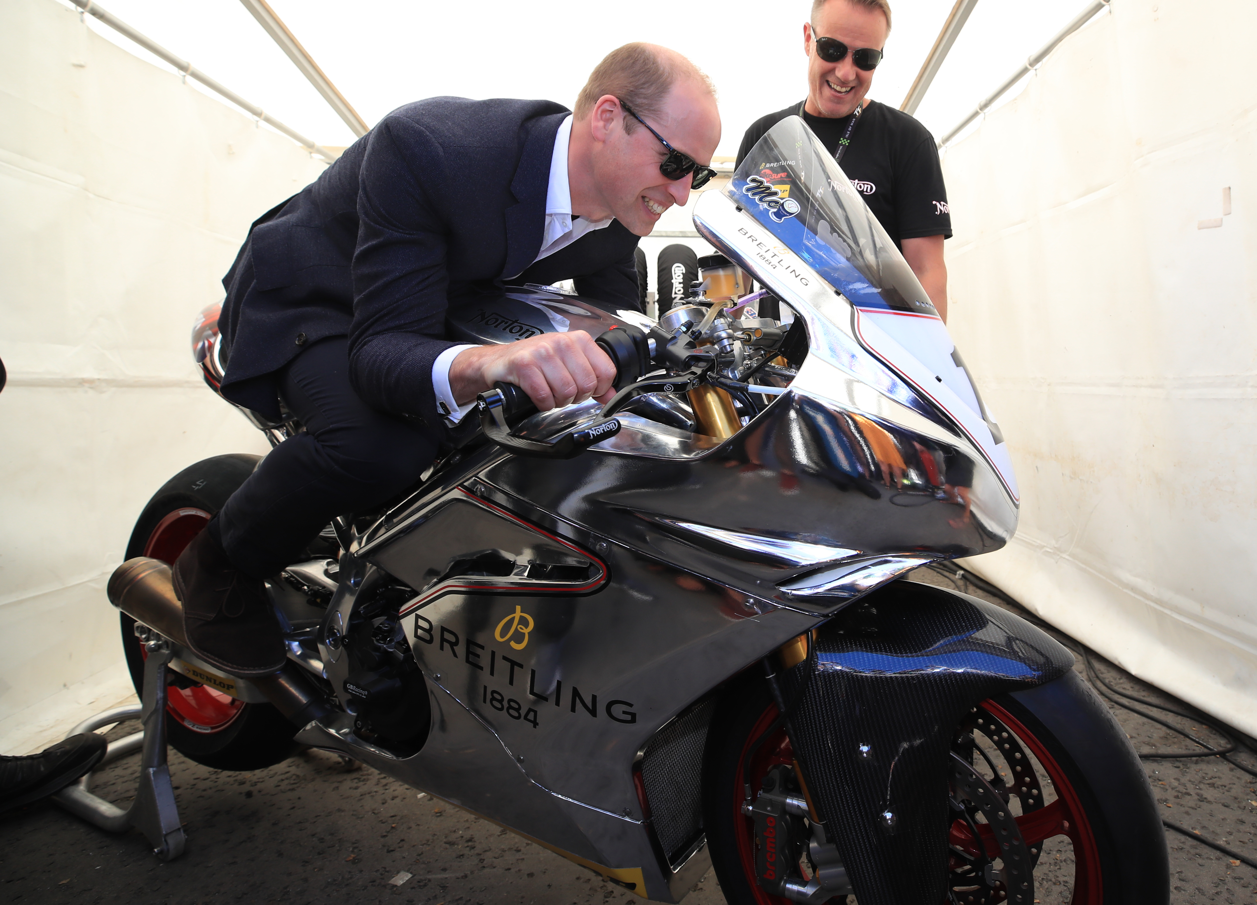 The Duke of Cambridge tries out a motorbike at the Isle of Man TT during his visit to the island.