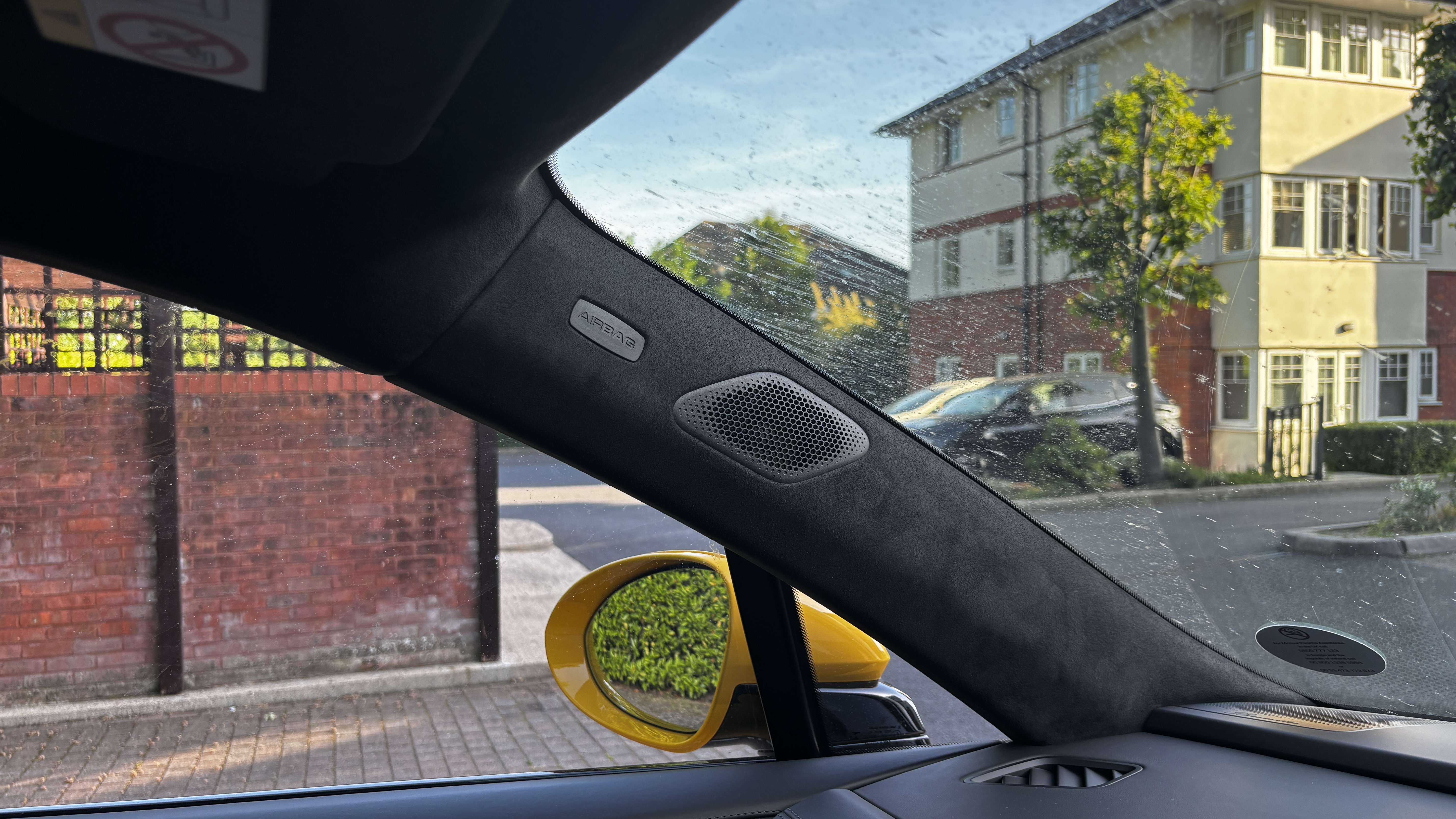 A-pillar of the Porsche Macan Electric showing a full-range driver plus an AMT tweeter in the corner of the dashboard