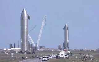 SpaceX's Starship SN10 (left) rolls out to its test stand while the company's Starship SN9 stands on its own pad at the company's South Texas facility near Boca Chica Village on Jan. 29, 2021.