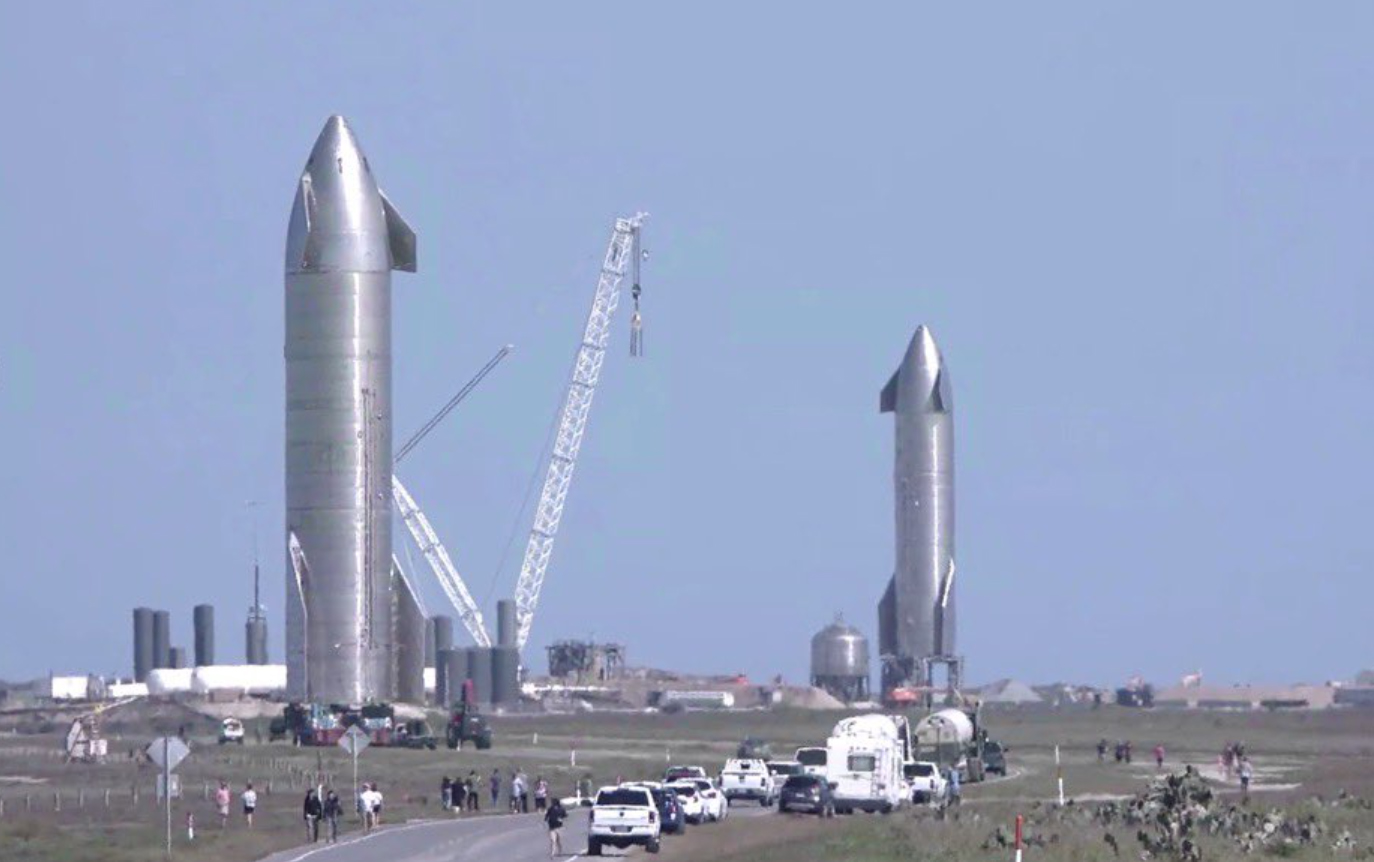 SpaceX's Starship SN10 (left) rolls out to its test stand while the company's Starship SN9 stands on its own pad at the company's South Texas facility near Boca Chica Village on Jan. 29, 2021.