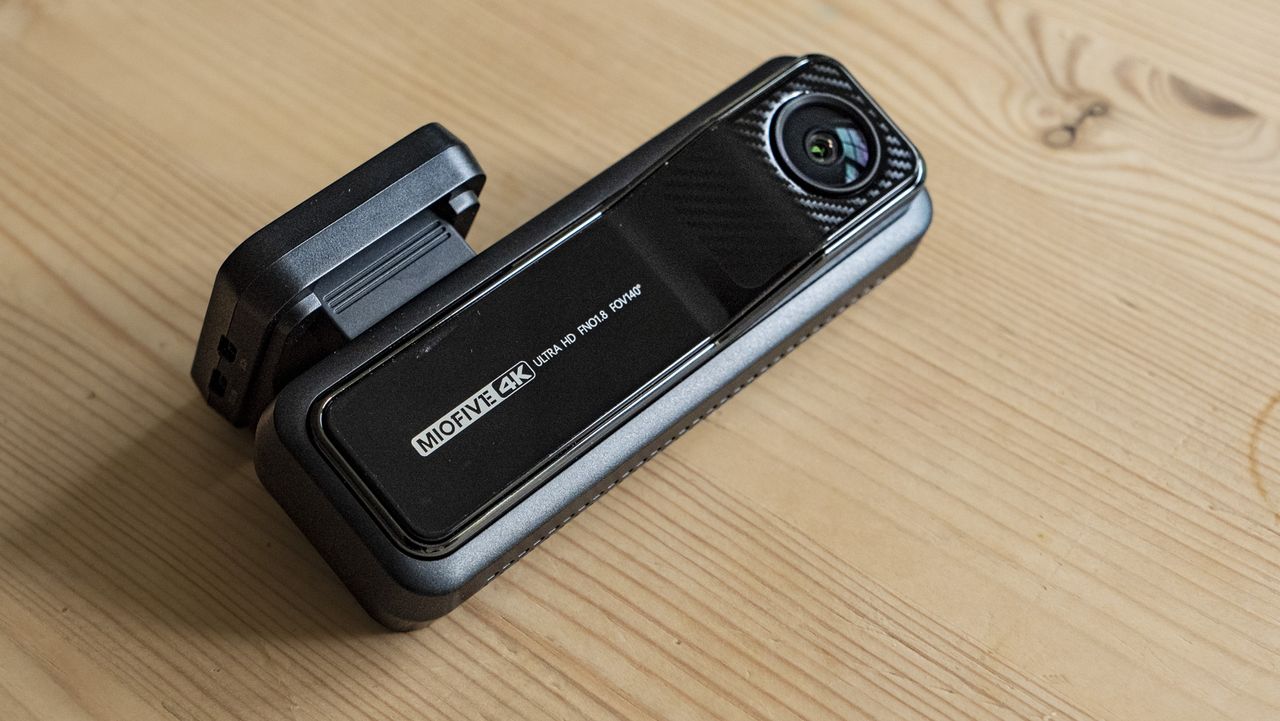 Miofive Dual Dash Cam front camera on a wooden table