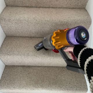 Using the Dyson hair screw tool on cream carpeted stairs