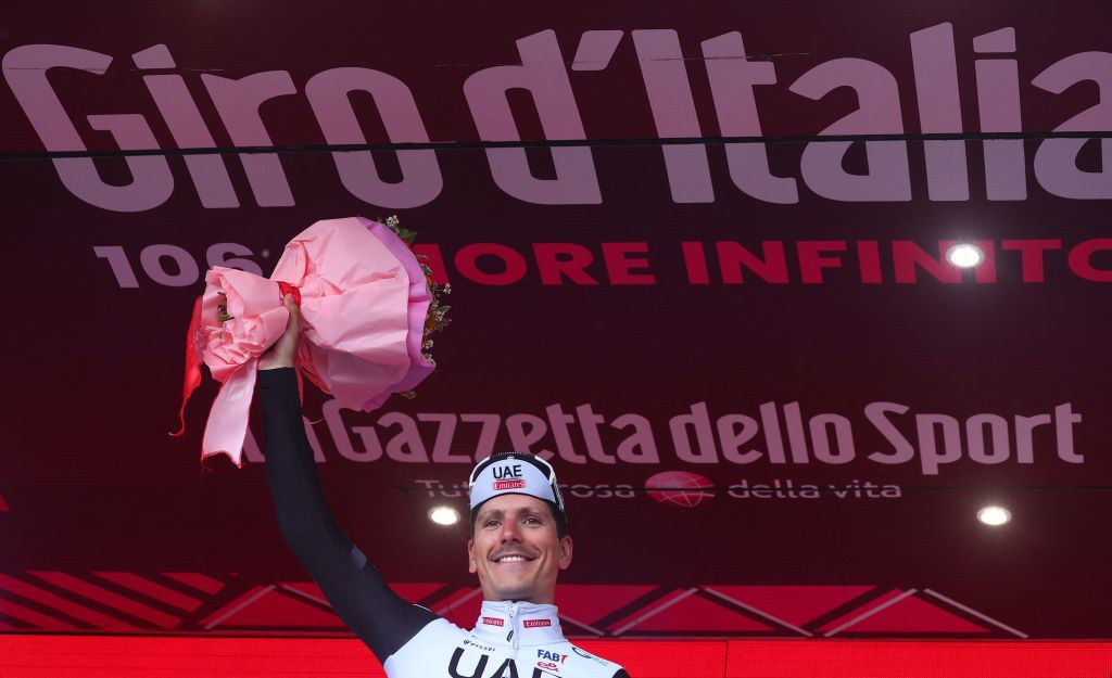 UAE Team Emiratess Portuguese rider Joao Almeida celebrates on the podium after winning the sixteenth stage of the Giro dItalia 2023 cycling race 203 km between Sabbio Chiese and Monte Bondone near Cavedine on May 23 2023 Photo by Luca Bettini AFP Photo by LUCA BETTINIAFP via Getty Images