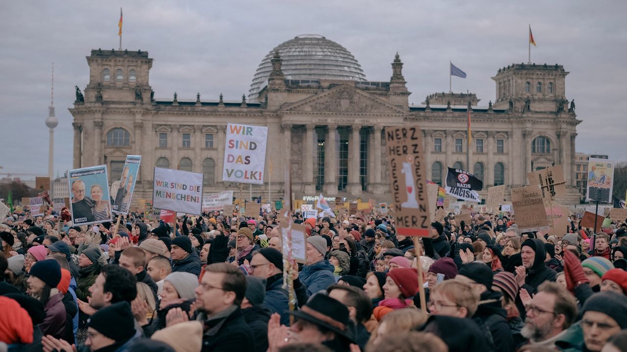 Protestors gather outside the Reichstag in Berlin during a demonstration against the growing collaboration between the Christian Democratic Union and the far-right Alternative for Germany (AfD) party