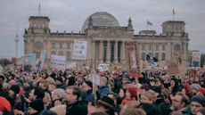 Protestors gather outside the Reichstag in Berlin during a demonstration against the growing collaboration between the Christian Democratic Union and the far-right Alternative for Germany (AfD) party