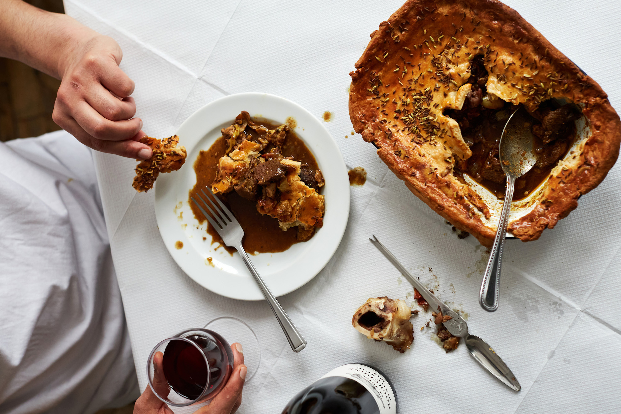 Aerial view of a male diner eating a spiced game pie