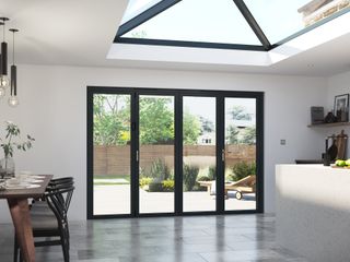A modern kitchen with roof lantern and bi-fold doors