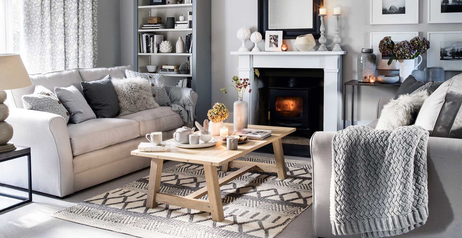 cosy grey living room with fireplace and candlelight