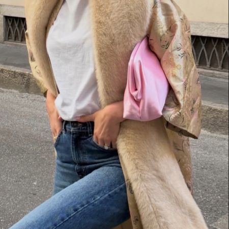 Sara Walker in a jacquard coat and pink satin clutch