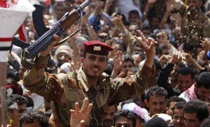 Yemeni soldiers are lifted in the air by anti-government protesters Sunday, during a celebration of the (potentially permanent) departure of President Ali Abdullah Saleh.