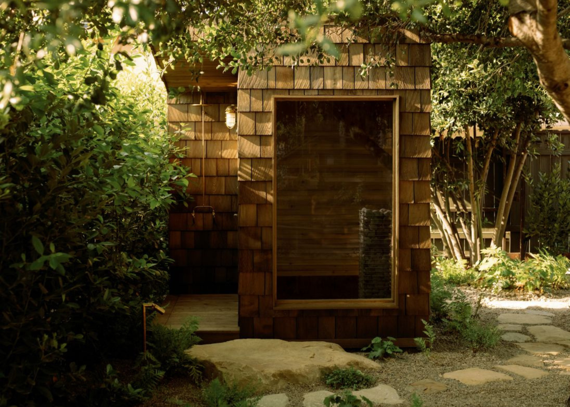 sauna with a shower in a pebble stone garden