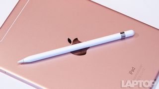 iPad Pro 9.7 in Rose Gold with an Apple Pencil resting on the back