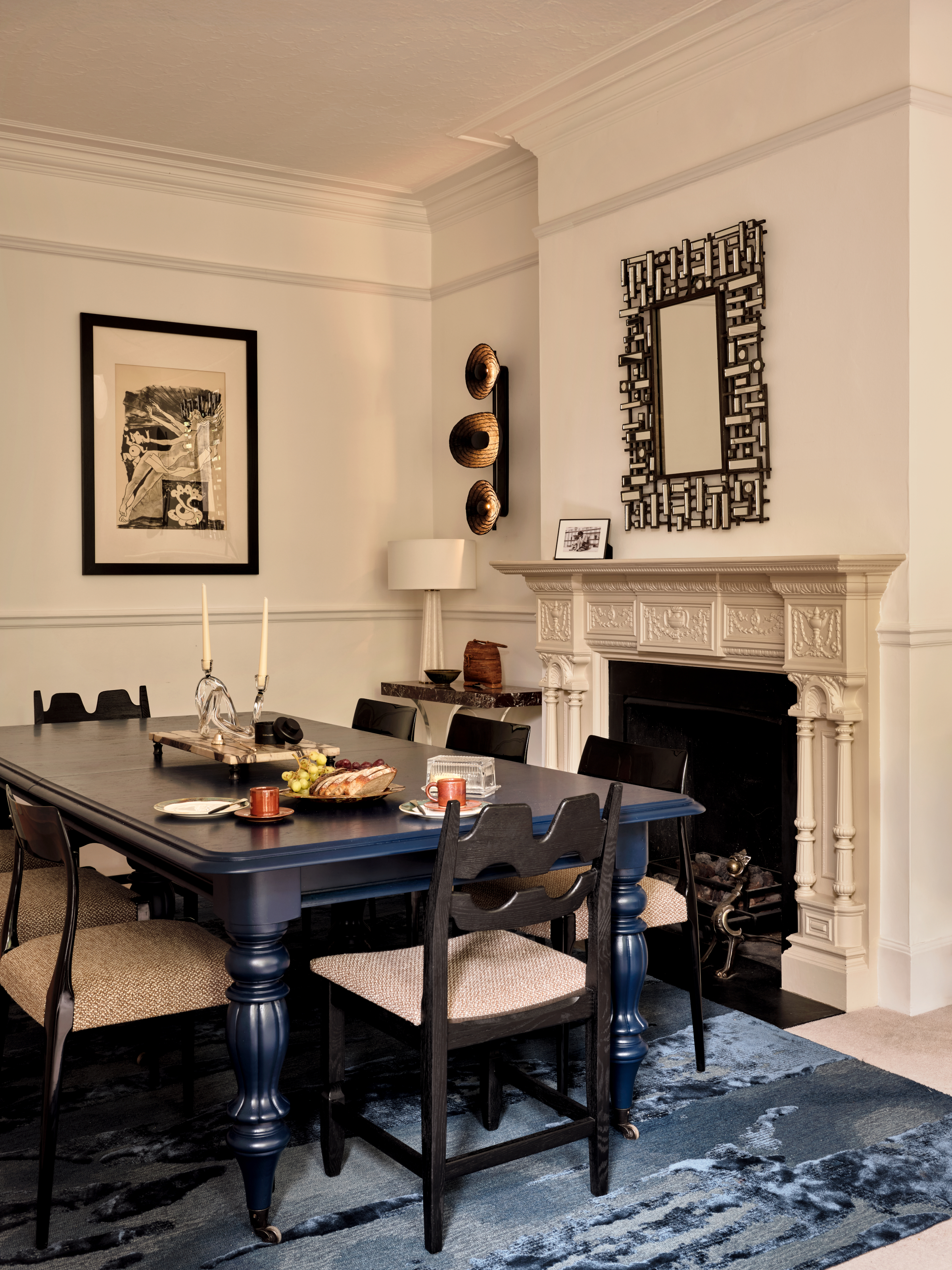 Cream dining room with dark blue lacquered table and black lacquered chairs