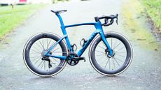 A blue Pinarello Dogma with Scope Artech 6A wheels fitted