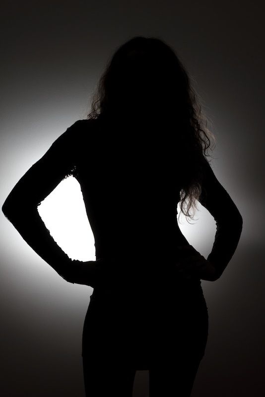 Woman&#039;s backlit silhouette.