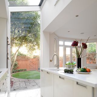 kitchen extension with white windows and tap with white sink