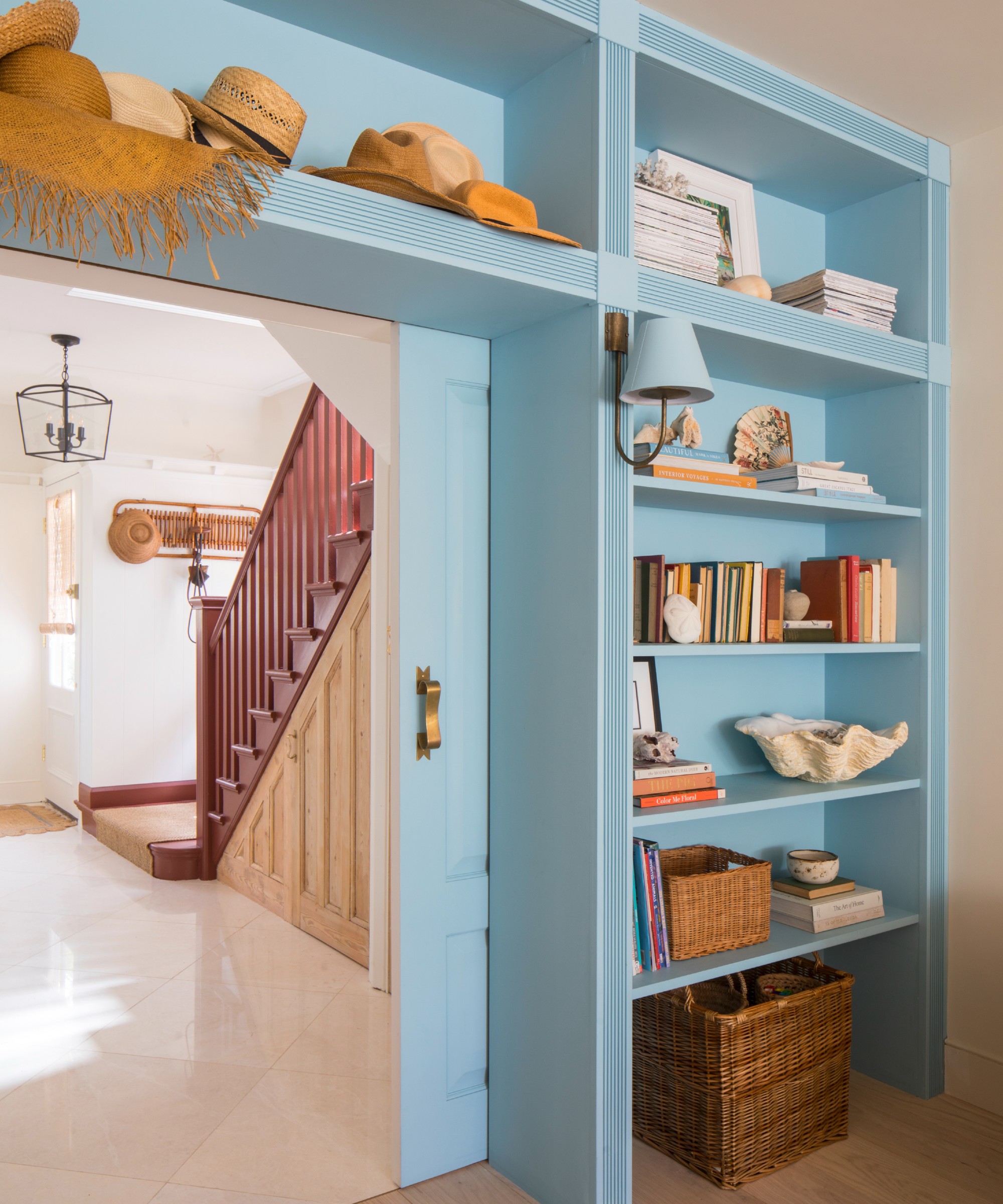 Built-in bookshelves in sky blue built in around living room pocket doors