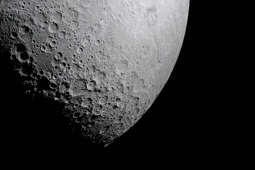 A photograph of the moon, showing a portion of its far side. 