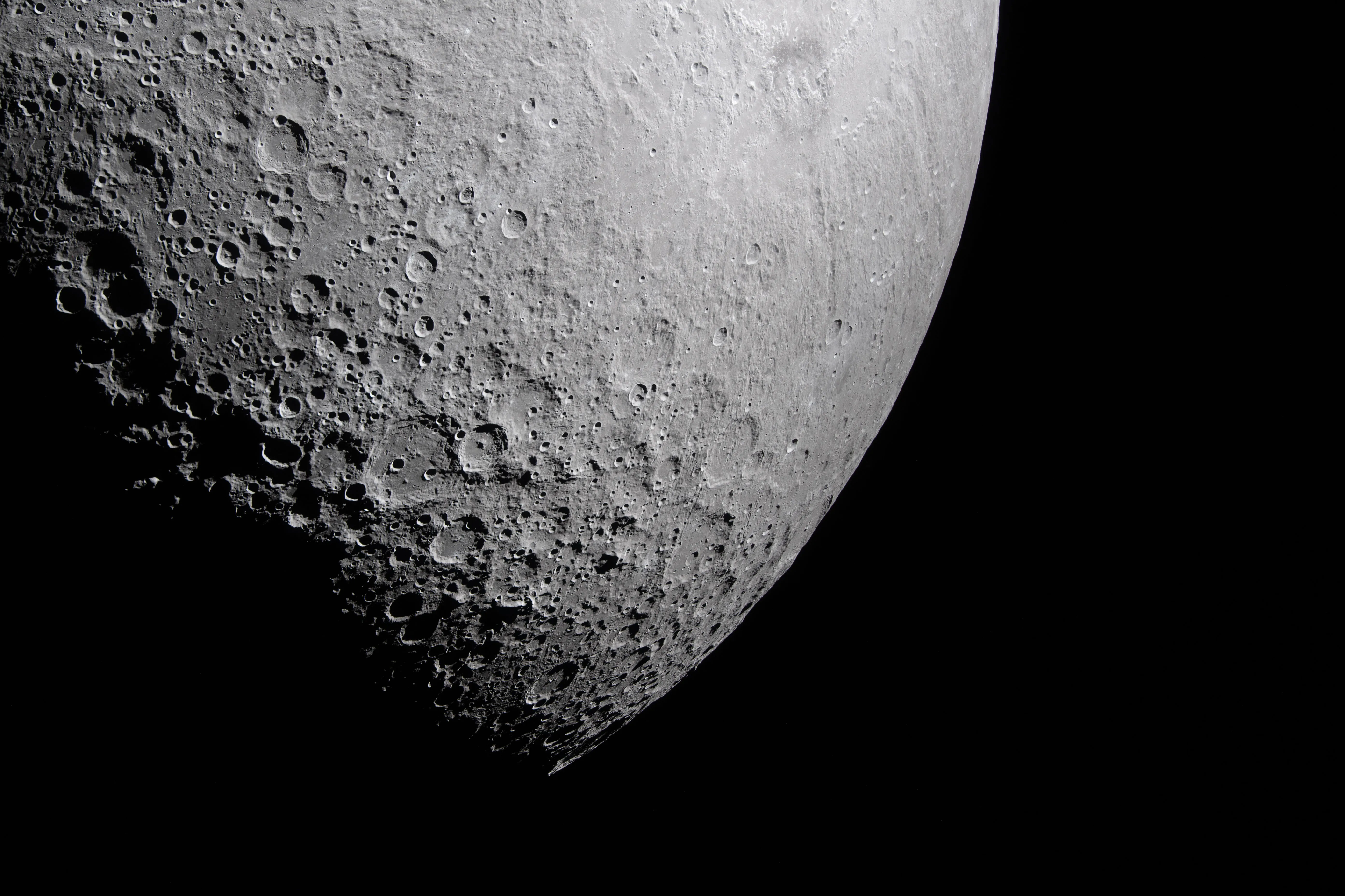 A photograph of the moon, showing a portion of its far side. 