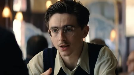 Timothee Chalamet in glasses and small mustache in his power house performance in Marty Supreme (2025). 