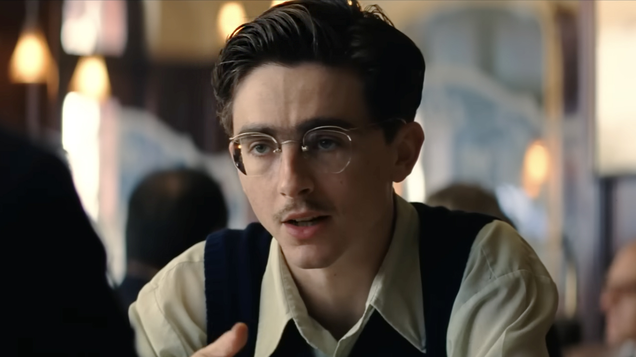 Timothee Chalamet in glasses and small mustache in his power house performance in Marty Supreme (2025). 