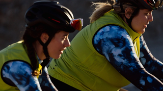 A close up of two women cycling side by side. One of them is visibly larger bodied.