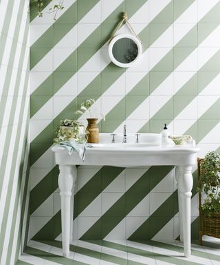 Green and white candy striped tiles in bathroom