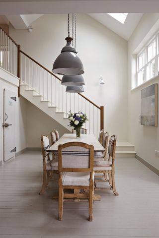 Slipper Satin, the best warm white paint, used in a dining room with dining table in the middle