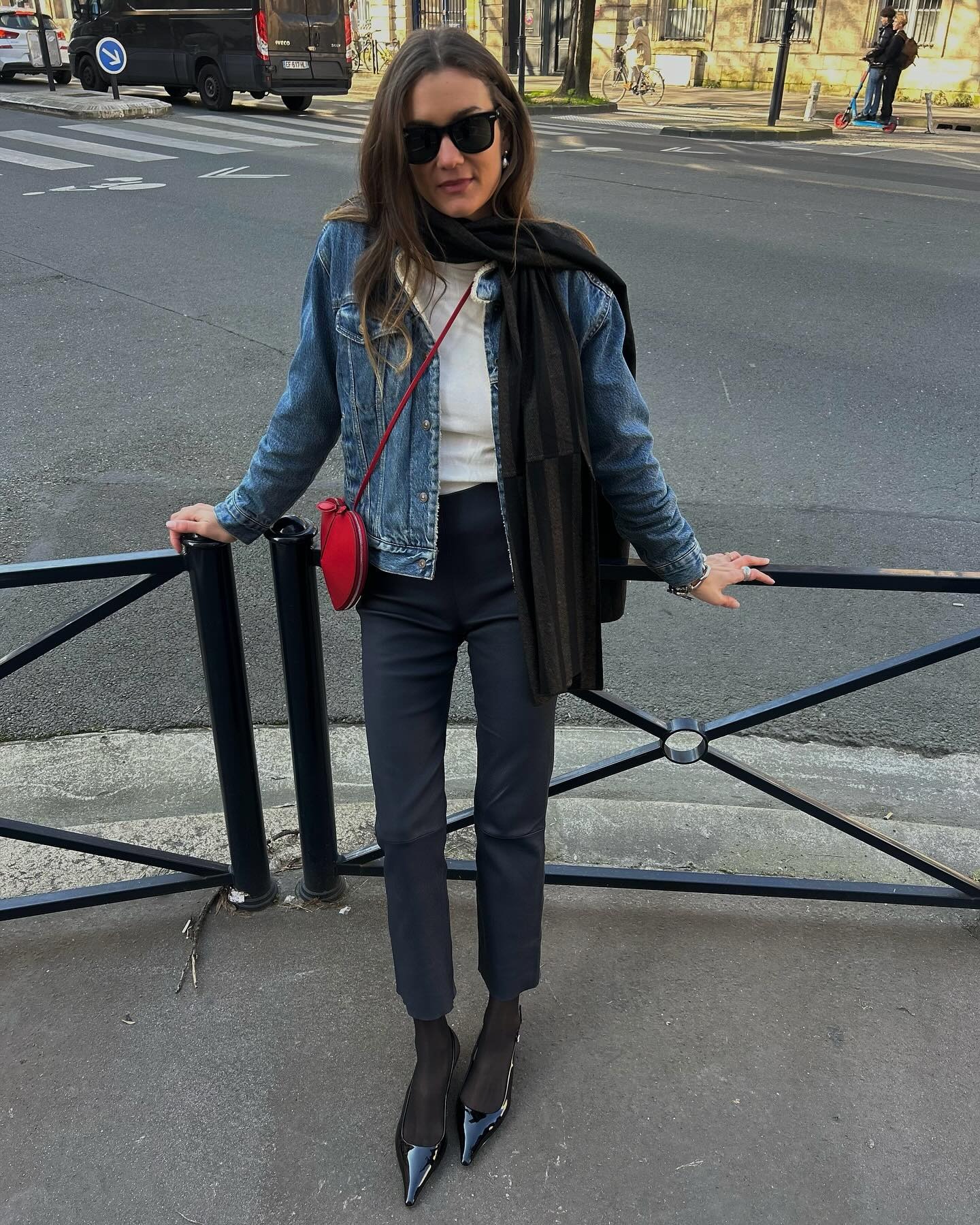 Influencer @annelauremais wears patent leather pointed-toe heels with cigarette trousers and a denim jacket.