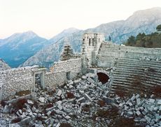 mountains behind stone monument ruins