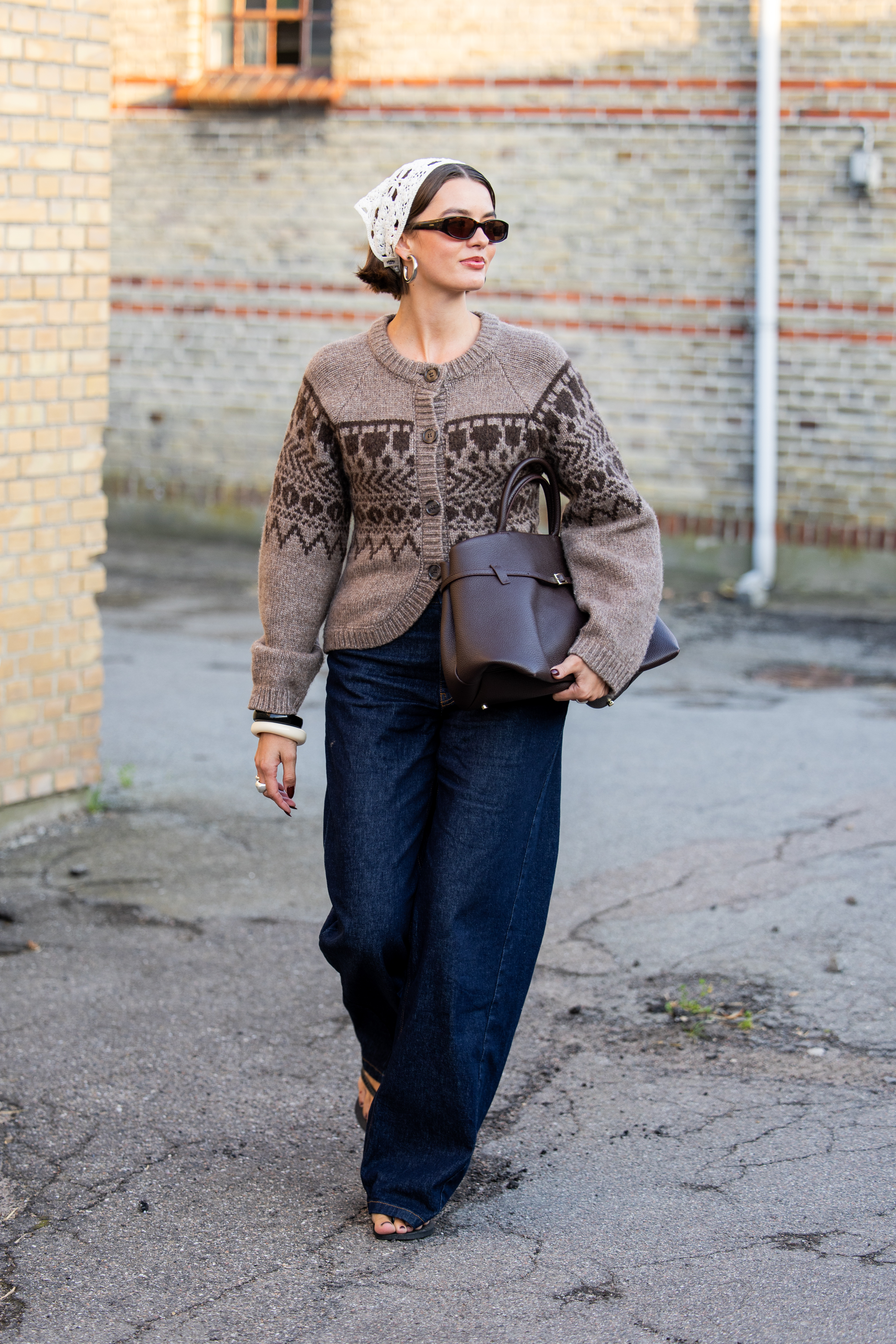 Woman in dark wash denim jeans and cardigan