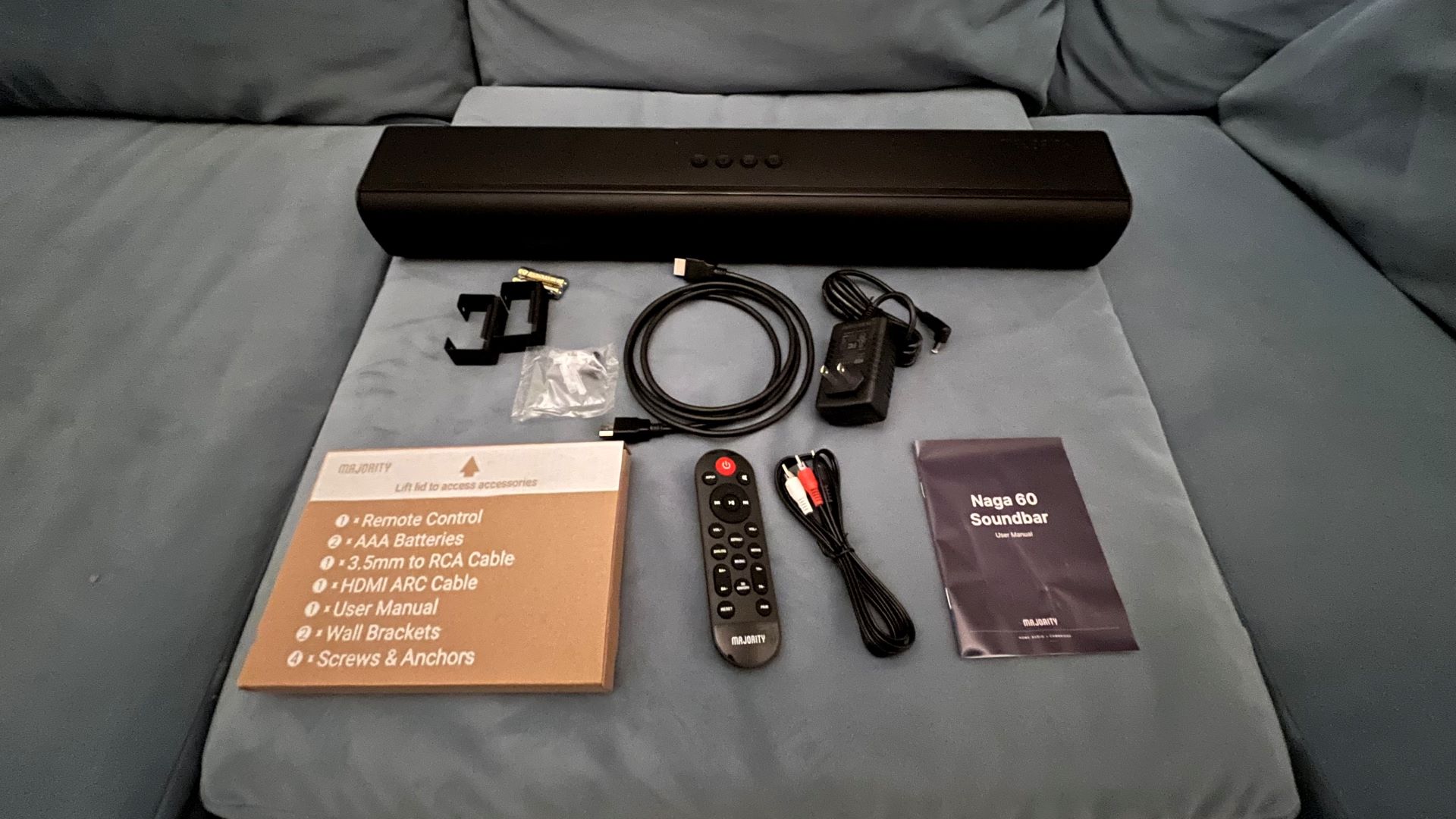 Majority Naga 60 soundbar on sofa with accessories